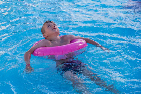 Happy child playing in water pool, fun summer. recreation cuteの写真素材