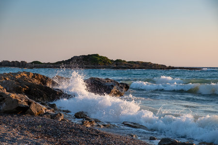 Sunset beach ocean wave splash summer storm. stone coastの写真素材