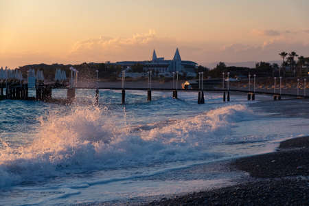 Orange sunset ocean pier and summer beach sky. horizon waveの写真素材