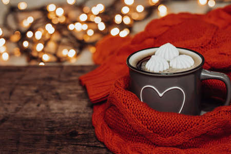 Cup of coffee with marshmallows on a wooden table. Beautiful bokehの写真素材