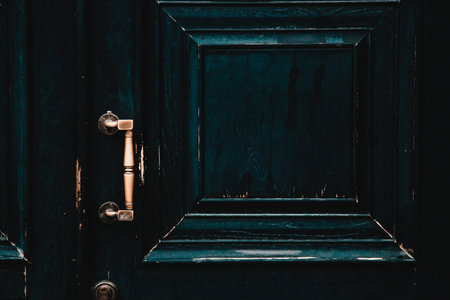 Vintage shabby black doors with gold handleの写真素材