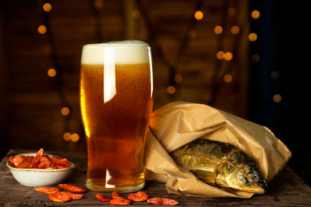 Glass of beer and a snack - smoked fish and shrimpの写真素材