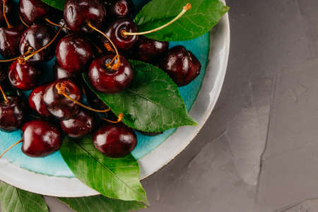 Ripe cherries on a beautiful plateの写真素材