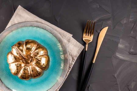 Plate on a napkin and cutlery on a concrete background. Autumn servingの写真素材