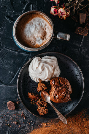 Chocolate muffin with whipped cream and cappuccino, top view