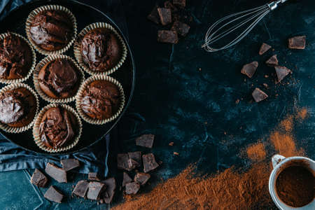 A lots of chocolate muffins on black background, free space for textの写真素材