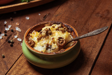 Julienne in a pot on a wooden rustic table. High quality photo
