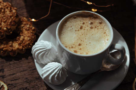 Cup of coffee with meringues, warm cozy photo. High quality photoの写真素材