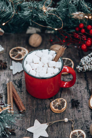 Red mug of cocoa with marshmallows in a New Year's environment. Cozy holidays concept. High quality photoの写真素材