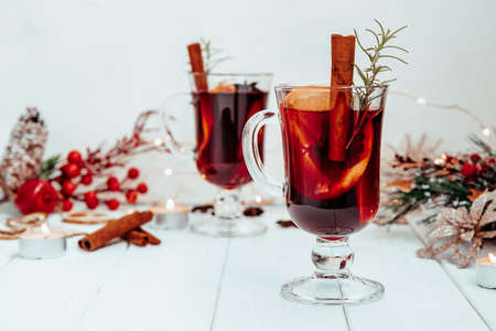 hot homemade mulled wine with rosemary on a white plate in a New Year's atmosphere. High quality photoの写真素材