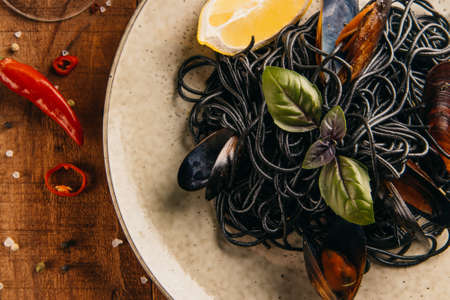Black pasta with mussels close-up. Gourmet dinner. High quality photoの写真素材