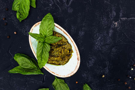Italian pesto sauce with fresh basil on black background. High quality photoの写真素材