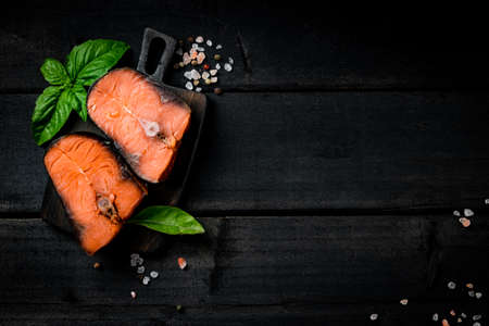Sliced ââsalted red fish on a board, top view, free space for your textの写真素材