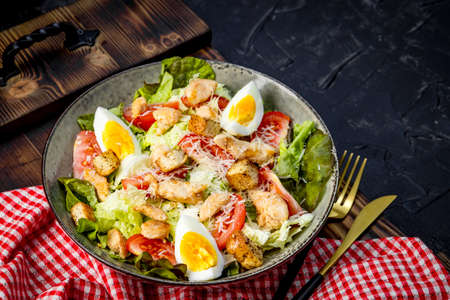 Caesar salad with chicken and eggs on a plate close-up. High quality photoの写真素材