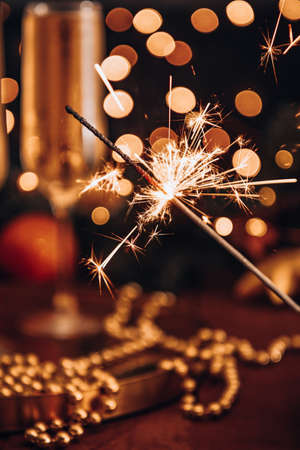 Burning sparkler in a christmas atmosphere at night. High quality photoの写真素材