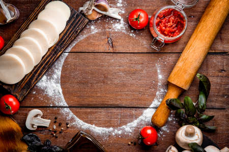 Pizza ingredients on wooden background with free space for text. High quality photoの写真素材