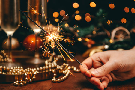 Burning sparkler in a christmas atmosphere at night