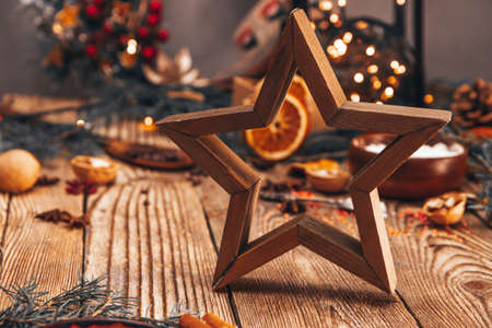 wooden star on the background of christmas decorationsの写真素材