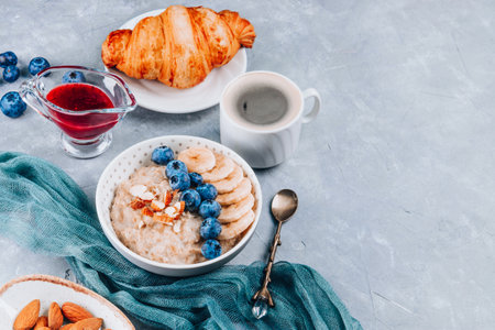 Healthy breakfast - oatmeal, growing and coffee on a gray background, free space for text. High quality photoの写真素材