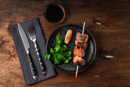 Baked salmon red fish kebab with lemon and herbs on wooden background, top view. High quality photoの写真素材