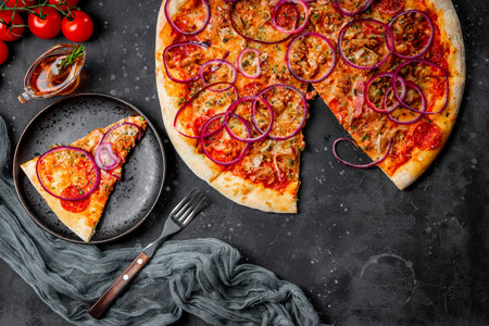 Classic Italian pepperoni pizza with onion on a plate, top viewの写真素材