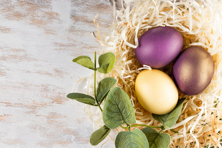 Colored easter eggs on a white background, top view, free space for text