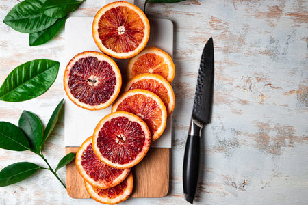 Red orange cut into slices on a cutting board top view. High quality photoの写真素材