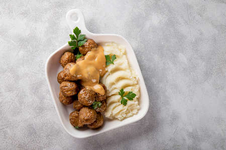 Traditional swedish meatballs with creamy sauce and mashed potatoes on gray background top view copy space for textの写真素材