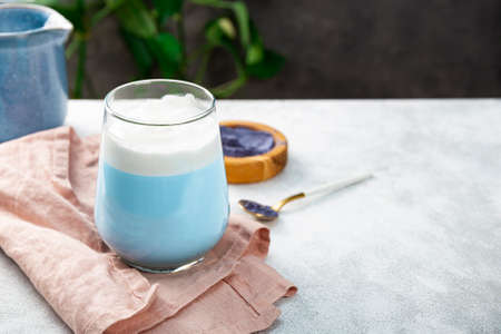 A glass of blue matcha latte, new trendy superfood healthy food, free space for textの写真素材