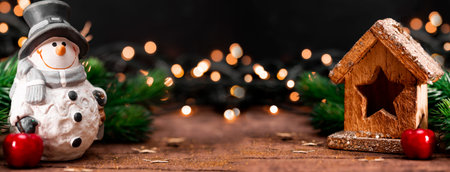Festive New Year banner with free space for text. Snowman and Christmas decorations on a dark...
