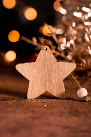 Festive New Year card with free space for text. Wooden star and Christmas decorations on a dark...