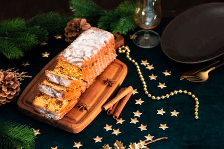 Traditional Christmas cake with fruits. Stollen on a festive Christmas table. Selective focus photo with copy space for textの写真素材