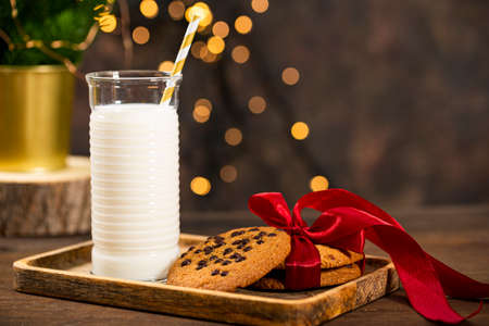 A glass of milk and cookies for Santa Claus. Christmas treat for Santa, copy space for textの写真素材