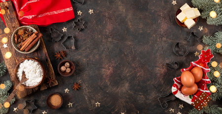 Products for making festive Christmas cookies. Ingredients for spicy cookies on a dark background,...