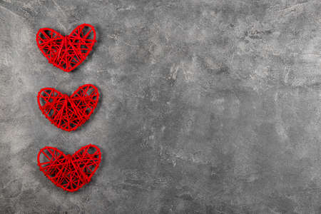 Valentines day background with red hearts on a gray background, greeting card with free space for textの写真素材