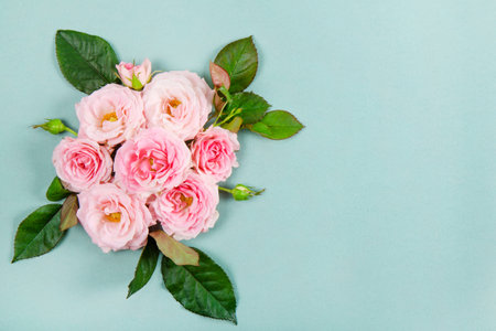 Beautiful summer and spring card with a bouquet of pink roses on a modern green background. Bouquet...