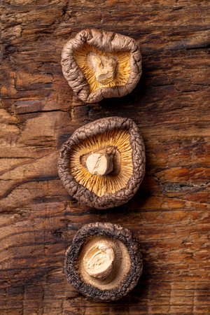Dried shiitake mushrooms on a wooden background top view vertical photo