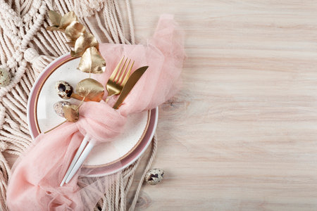 Easter table setting in boho style. Plate, cutlery and quail eggs on the Easter table, copy space for textの写真素材