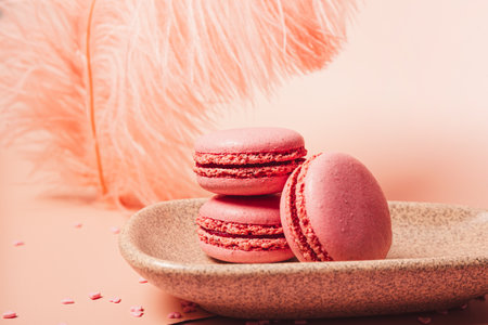 Italian macarons and confetti hearts on a pink background, Valentine's Day card with copy space. High quality photoの写真素材