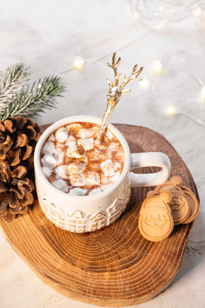 A mug of cocoa with marshmallows on a New Year's table on a white background. festive and cozy Christmas vertical card. High quality photoの写真素材