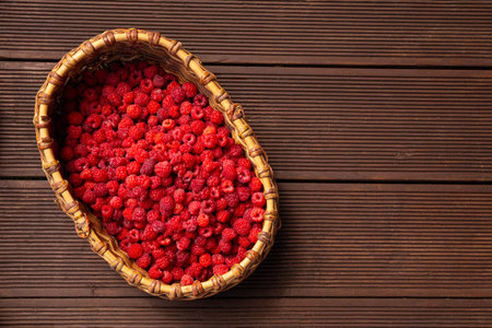 A full basket of fresh raspberries picked from the garden top view. High quality photo