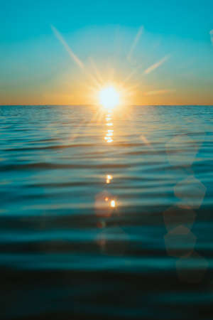 Sun rising over the water at Mollymook Beach.の写真素材