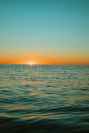 Sun rising over the water at Mollymook Beach.の写真素材