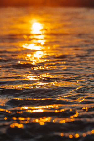 Colorful ocean beach sunrise with deep blue sky and sun rays.の写真素材