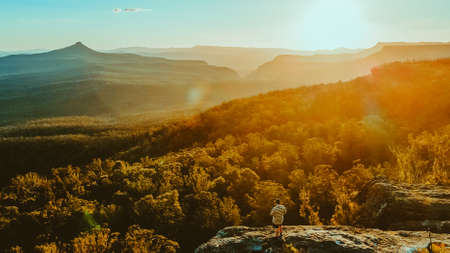 Man watching the Sunset at Pigeon House Mountain Ulladullaの写真素材