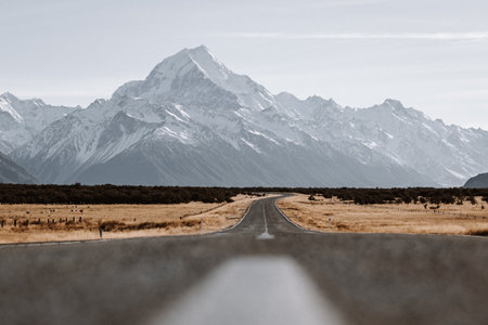 View of the majestic Aoraki Mount Cook with the road leading to Mount Cook Village. Taken during winter in New Zealand.の写真素材