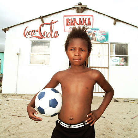 Boy posing with a ball. Township in South Africa.のeditorial素材