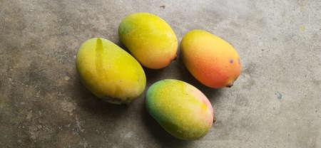 Ripe and red Mangoes on the floor.の写真素材