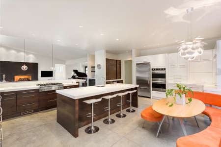 Kitchen with Island, Sink, Cabinets, and Hardwood Floorsの写真素材