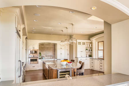 Kitchen with Island, Sink, Cabinetrs, and Hardwood Floorsの写真素材